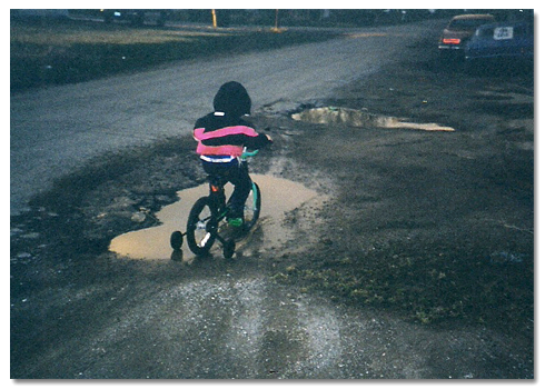 Photo Brock Walquist riding his bike in the mud.